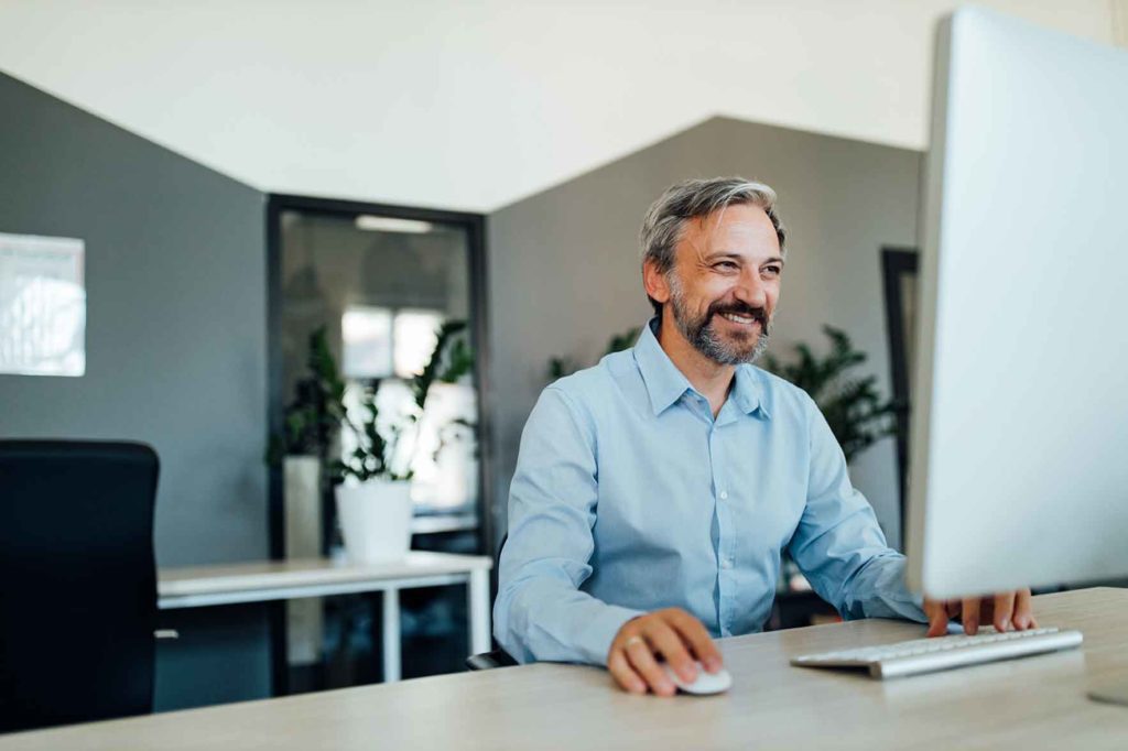 A man at home using his computer