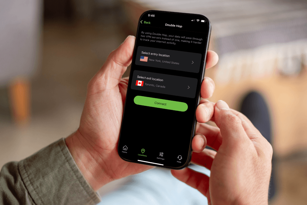 A person holds a phone displaying the Double Hop VPN server selection screen in the IPVanish mobile app