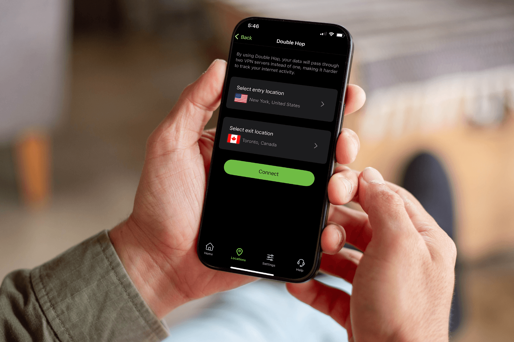 A person holds a phone displaying the Double Hop VPN server selection screen in the IPVanish mobile app