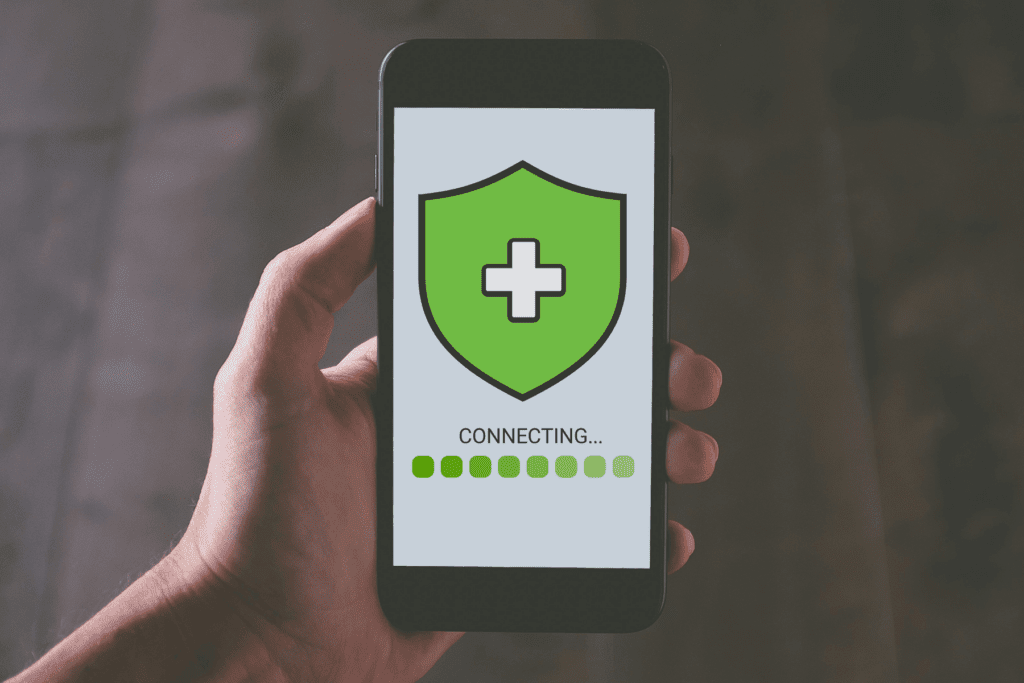 A decorative image with a mobile phone displaying an Emergency VPN logo as it establishes a connection