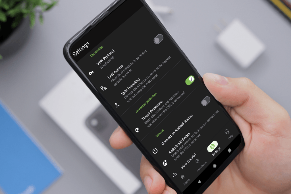 A person with an Android phone enables the Threat Protection feature by IPVanish