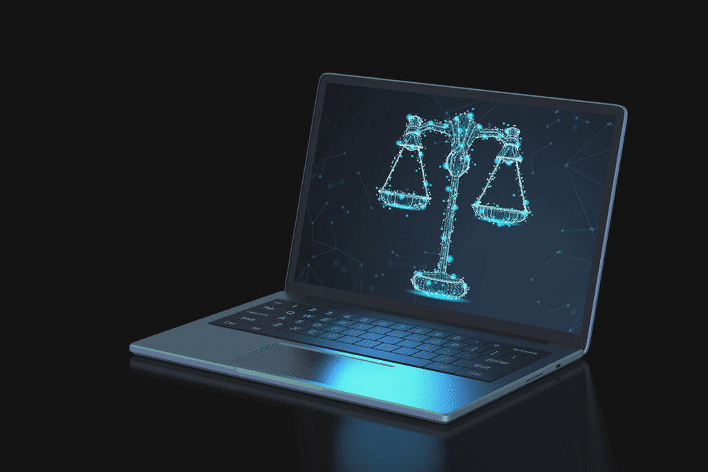 Are VPNs legal? A laptop sits on a black background with a digital rendering of justice scales displayed